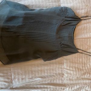 Grayish blue top with real shell buttons at the sides. 100% silk.